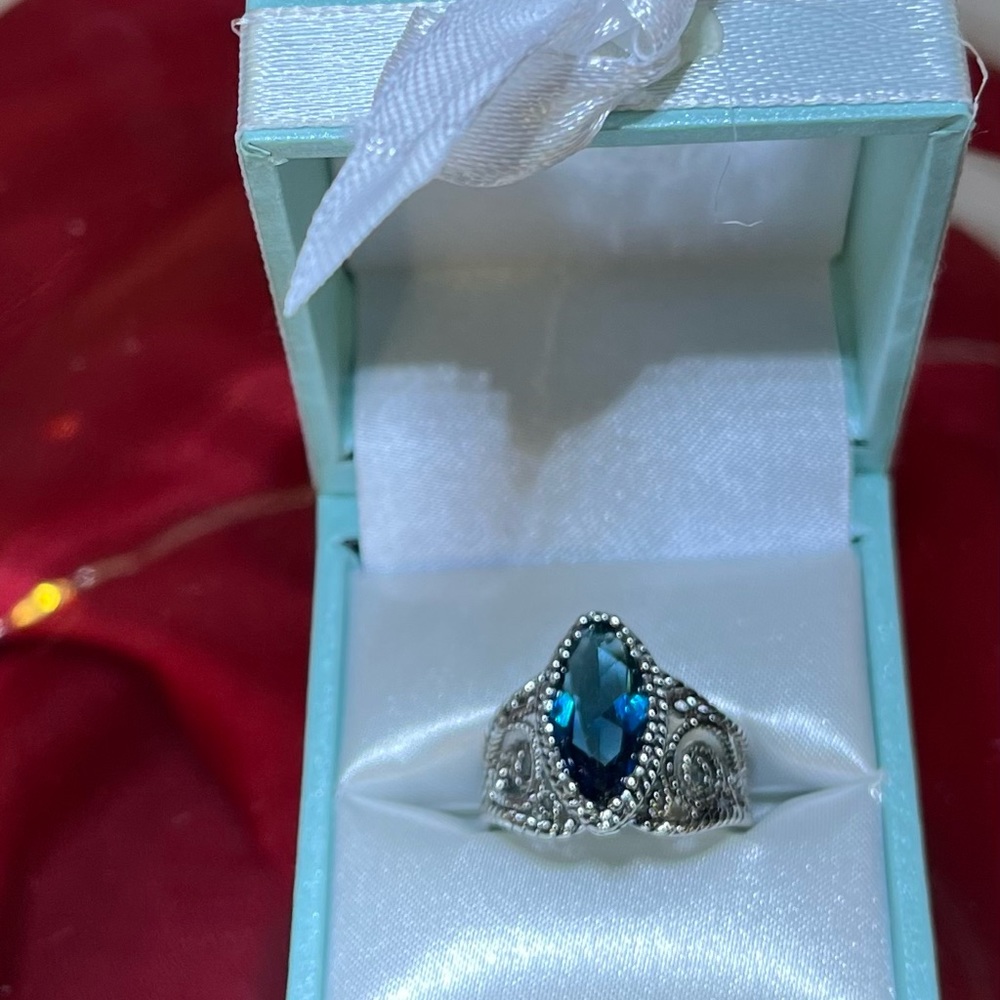 Silver tone - Blue-Topaz Color   Size 8 ring in original box